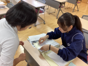 書類を丁寧にファイルにとじている様子です。