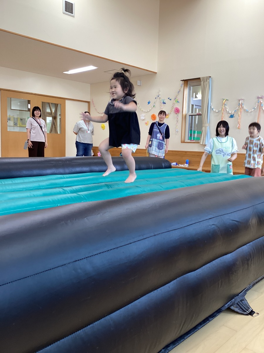 エアートランポリンの上で女の子が元気にジャンプしている写真