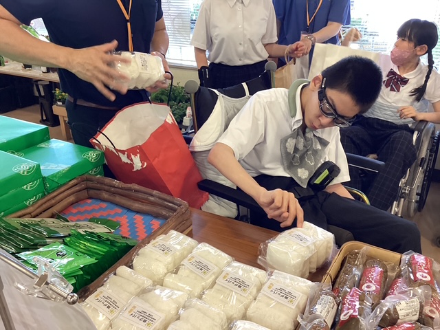 写真：商品を丁寧に陳列している生徒