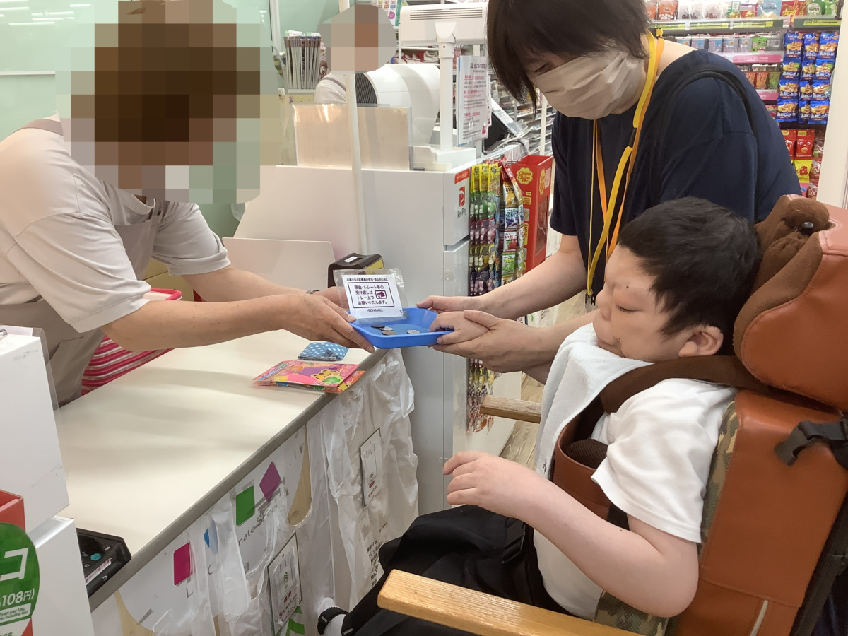 写真:お金を支払う生徒